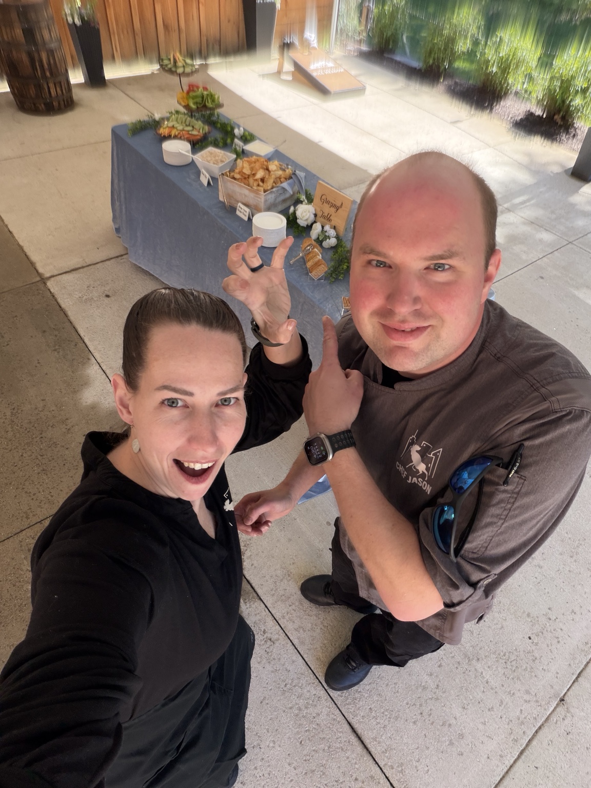 Stacy and Chef Jason together beside a City Moose grazing table at an event