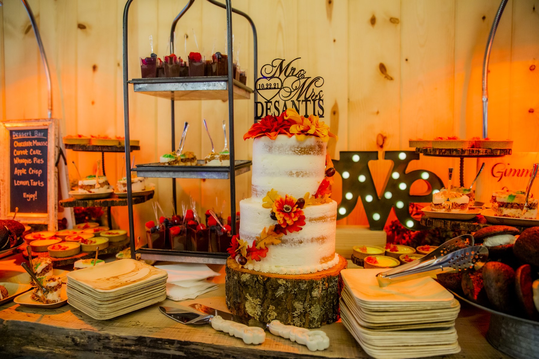 An autumn wedding dessert table with assorted miniature desserts